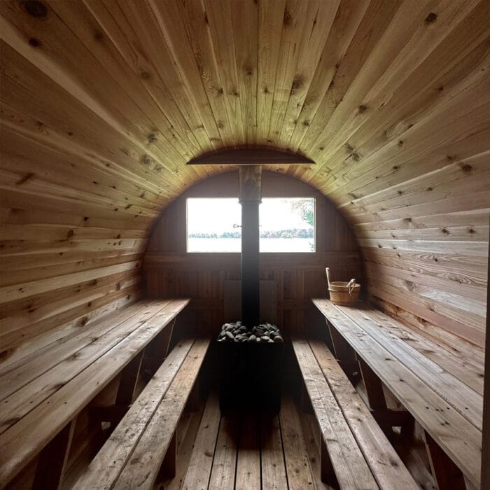 Outdoor cedar shower and cold plunge tub paired with mobile sauna package