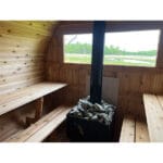 Side view of mobile sauna unit with complete accessory package including cold tub and log rack