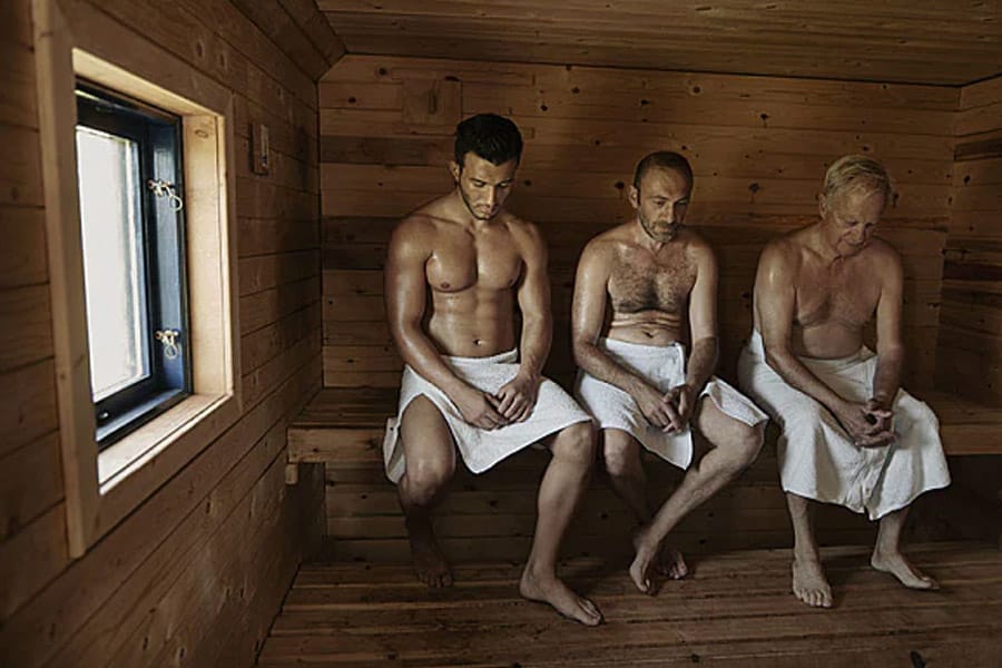 Person relaxing inside a wood-fired barrel sauna during a mobile rental experience