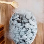 HUUM Drop heater shown in operation inside small home sauna