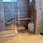 Installation setup showing HUUM Drop heater on cedar paneling