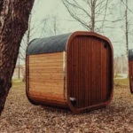 panoramic glass cube sauna in natural setting