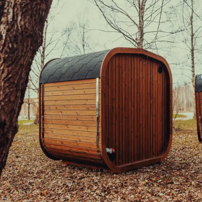 panoramic glass cube sauna in natural setting