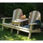 Side profile of durable Cedar Adirondack Settee, featuring weather-resistant design, wide slats, and built-in table in this adirondack chair settee for decks.