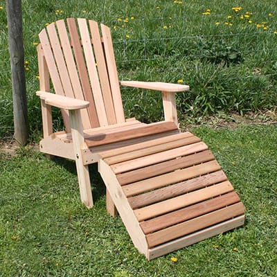 Front view of Cedar American Forest Adirondack Chair & Footrest Set, an adirondack chair wood pairing from Western Red Cedar with sloped chair and matching ottoman for extended lounging.