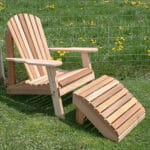 Side profile of the Cedar American Forest Adirondack Chair & Footrest Set, highlighting ergonomic curves, tawny veneer, and detachable footrest in this adirondack chair wood ensemble.