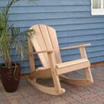 Cedar Adirondack Rocking Chair in porch environment, highlighting rich golden patina and ergonomic design as a timeless adirondack rocking chair for retreats.