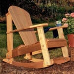 Side profile of resilient Cedar Adirondack Rocking Chair, featuring weather-resistant construction, contoured seat, and smooth gliding motion in this adirondack rocking chair.