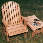 Red Cedar Fanback Patio Chair in garden placement, emphasizing golden-tinted veneer and curved back as a leisurely outdoor patio chair for restful nooks.
