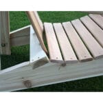 Cedar American Forest Adirondack Chair in patio setting, showcasing natural appeal and slanted structure as versatile unfinished wood furniture for gardens.