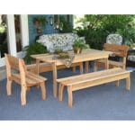 Cedar Gathering Dining Set in green space, emphasizing sun-kissed sheen and spacious layout as practical wood dining table for gatherings.