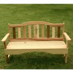 Cedar Holy Cross Garden Bench in outdoor setting, showcasing natural honey-brown hue, holy cross accents, and rustic charm as versatile solid wood furniture for patios or lawns