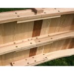 Close-up of railing and deck on Cedar Pearl River Garden Bridge, emphasizing zinc-layered hardware and smooth contours in resilient wood bridge material
