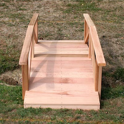Side profile of durable Cedar Pearl River Garden Bridge, highlighting curved design, weather-resistant Western Red Cedar construction, and sturdy decking in this wood bridge for ponds