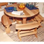 Cedar Round Trestle Dining Set in patio environment, highlighting tawny gloss and curved bench fit as compact round wood dining table for decks.