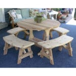 Side profile of durable Cedar Round Trestle Dining Set, showcasing benches nested under table, thick tabletop, and weather-resistant design in this round wood dining table.