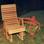 2' Cedar Twin Ponds Rocking Glider in patio setting, showcasing golden-toned finish and modern-classic design as inviting natural wood furniture for outdoors.