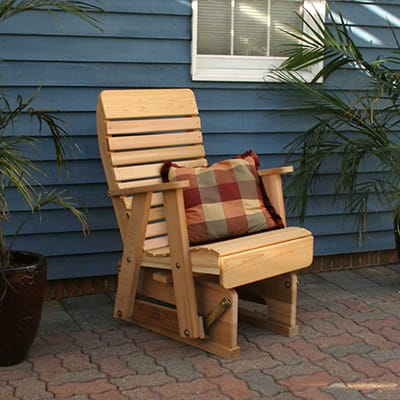 Side profile of durable 2' Cedar Twin Ponds Rocking Glider, highlighting contoured seat, upright arms, and smooth glide in this natural wood furniture rocker.