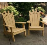 Cedar Wine Glass Adirondack Chair in backyard setting, showcasing tawny surface and functional holder as versatile wood outdoor furniture for serene corners