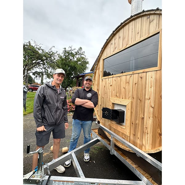 Sauna being delivered by trailer into a customer’s backyard