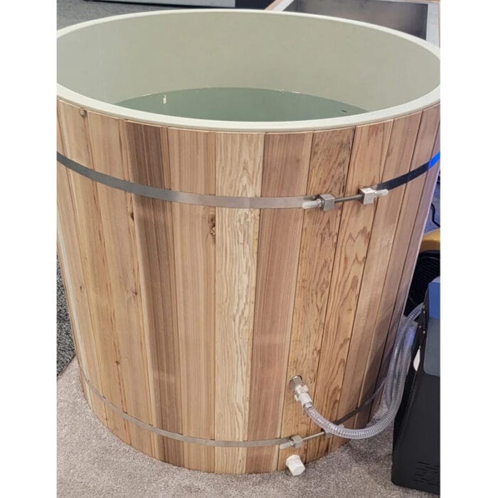 Athlete recovering in a PVC barrel cold plunge tub