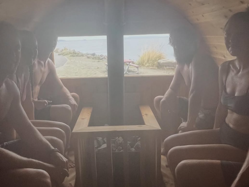 People relaxing inside Sauna N Soak Rentals barrel sauna