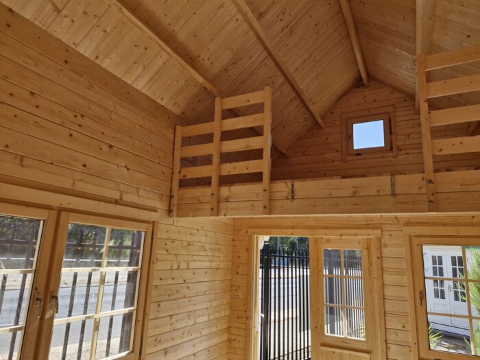 Log cabin kit style bunkie interior with picture window