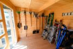 Modern backyard wood shed with dark stain finish